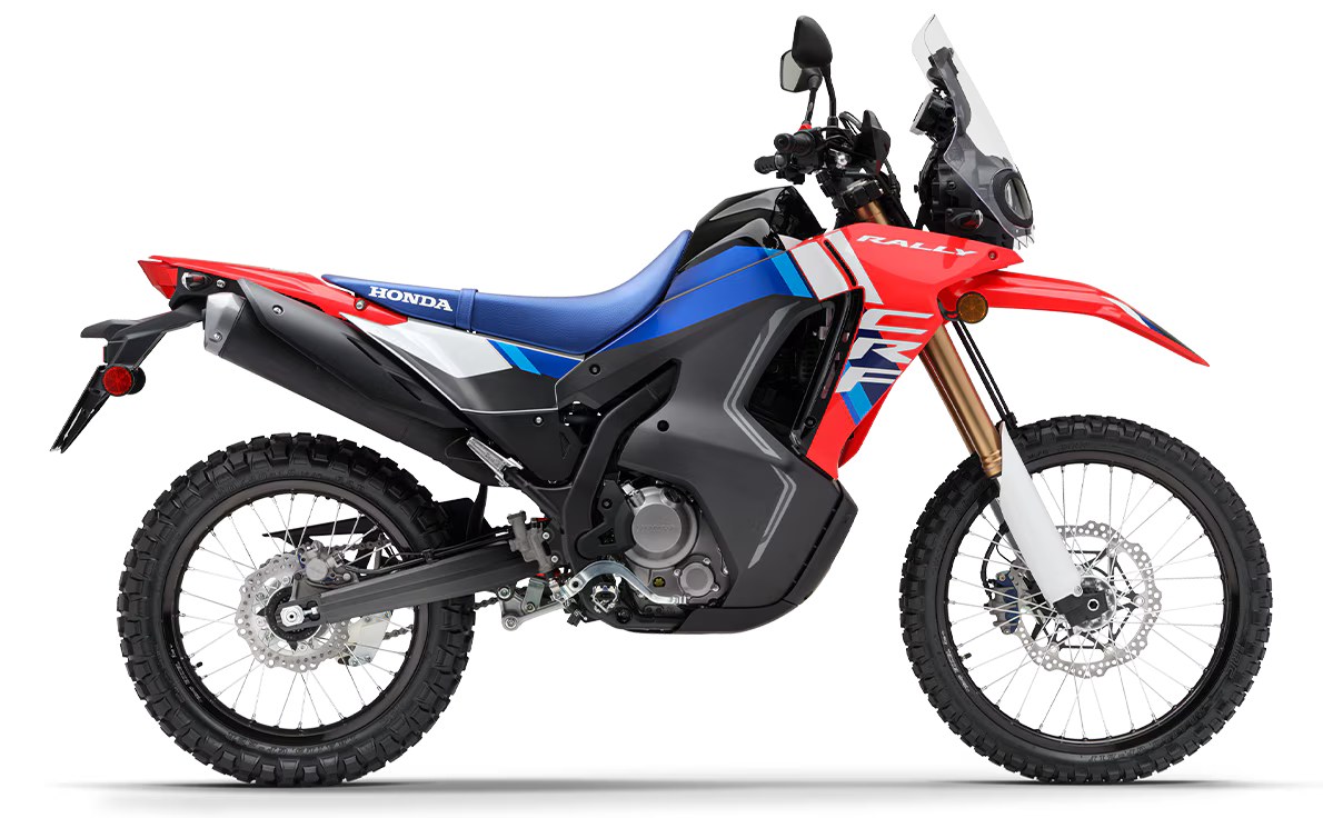 Honda CRF300 Rally, side on, red and blue with gold forks